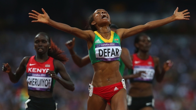 Meseret Defar celebrates as she crosses the line
