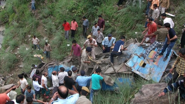 Onlookers and rescuers at the scene of a bus crash in northern India Onlookers and rescuers at the scene of a bus crash in northern India