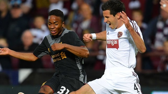 Liverpool's English midfielder Raheem Sterling (L) shoots past Hearts' Australian defender Ryan McGowan