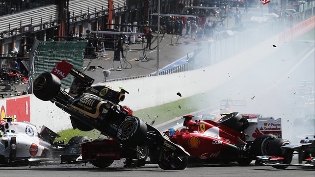 Romain Grosjean's car is catapulted into the air at the first corner in the Belgian Grand Prix