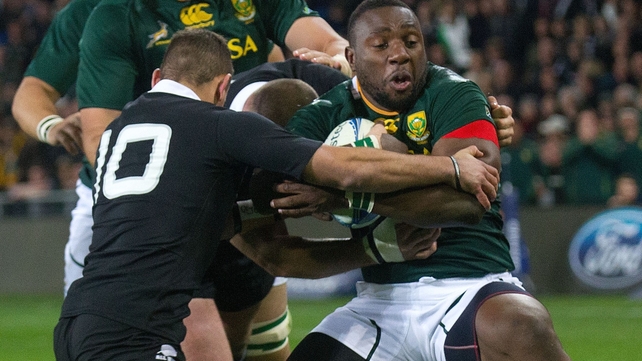 South Africa's Tendai Mtawarira is tackled by New Zealand's Aaron Cruden