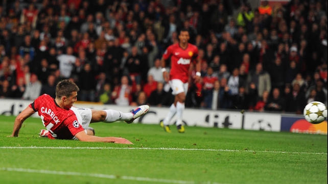 Michael Carrick goes to ground while netting the opener after only 7 minutes