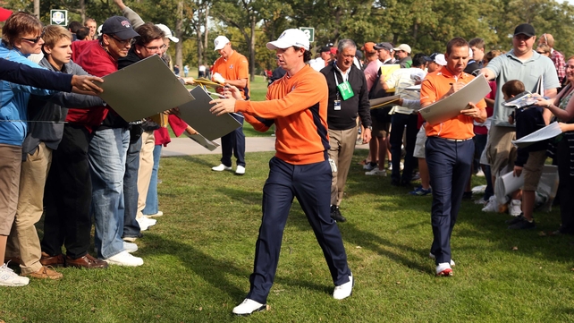 Rory McIlroy signs autographs yesterday at Medinah Country golf club
