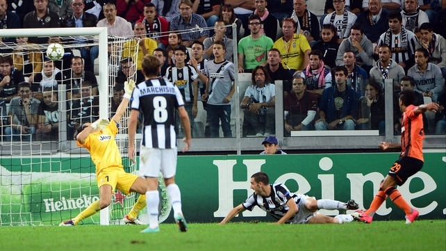 Juventus' goalkeeper Gianluigi Buffon is beaten by Shakhtar Donetsk's Brazilian forward Alex Teixeira