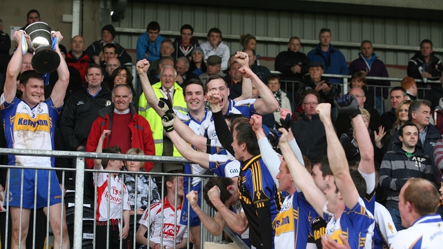 Enda McGinley holds the cup aloft as Errigal Ciarán celebrate