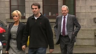 Seán Quinn Jnr leaves court with his wife and his father