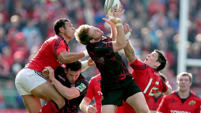 Munster's Casey Laulala and James Downey with Greig Tonks of Edinburgh