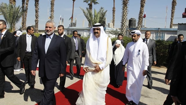 Qatari Emir Sheikh Hamad bin Khalifa al-Thani (r) walks alongside Gaza's Hamas prime minister Ismail Haniyeh (l) during a welcome ceremony at the Rafah border crossing with Egypt Qatari Emir Sheikh Hamad bin Khalifa al-Thani (r) walks alongside Gaza's Hamas prime minister Ismail Haniyeh (l) during a welcome ceremony at the Rafah border crossing with Egypt
