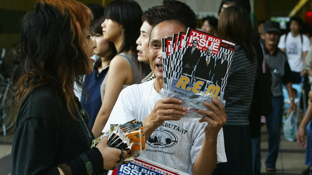 A Japanese homeless man sells The Big Issue magazine A Japanese homeless man sells The Big Issue magazine