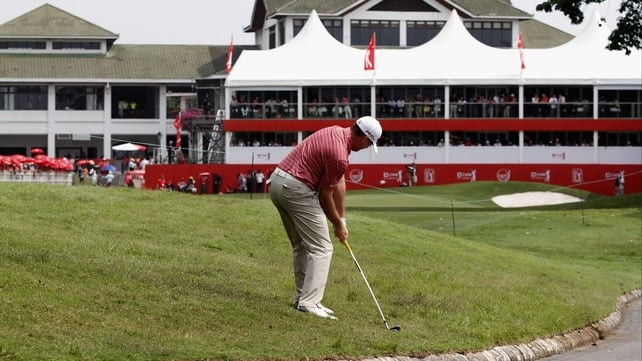 Robert Garrigus plays an approach shot towards the 18th hole