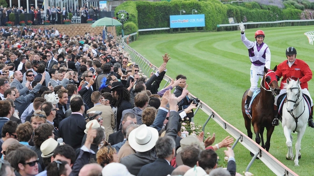 Jockey Glen Boss salutes the crowd after landing his third Cox Plate win in Melbourne