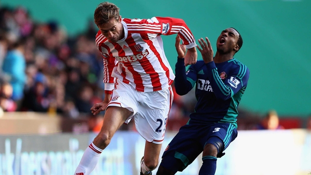 Stoke's Peter Crouch holds off Sunderland's Danny Rose at the Britannia Stadium