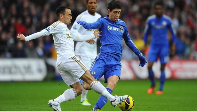 Oscar of Chelsea battles with Swansea's Leon Britton