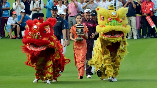 Ian Poulter is all smiles as he walks behind the HSBC trophy he won in China on Sunday