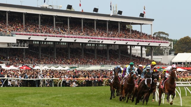 The field rounds the first bend at the Melbourne Cup