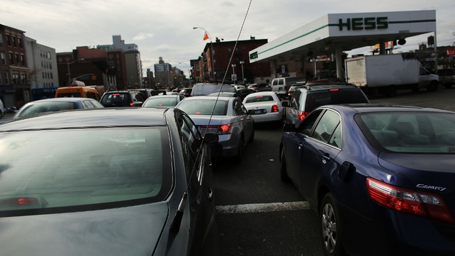 People wait in line for over two hours at a petrol station in New York City People wait in line for over two hours at a petrol station in New York City