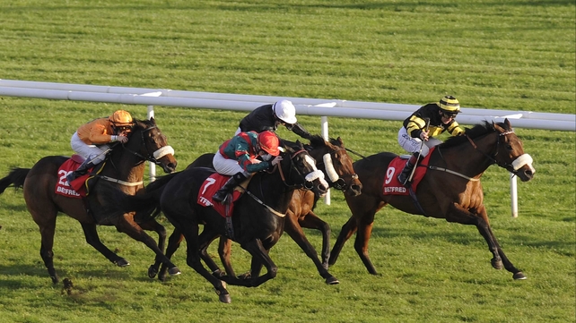Art Scholar and Franny Norton forge ahead of Communicator (nearside) and Voodoo Prince (white cap) to win the November Handicap