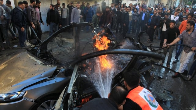 Palestinian firefighters extinguish fire from the car of Ahmaed Jaabari Palestinian firefighters extinguish fire from the car of Ahmaed Jaabari