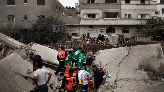 Palestinian firefighters and rescue personnel work at a blast site following an Israeli air raid in Gaza Palestinian firefighters and rescue personnel work at a blast site following an Israeli air raid in Gaza