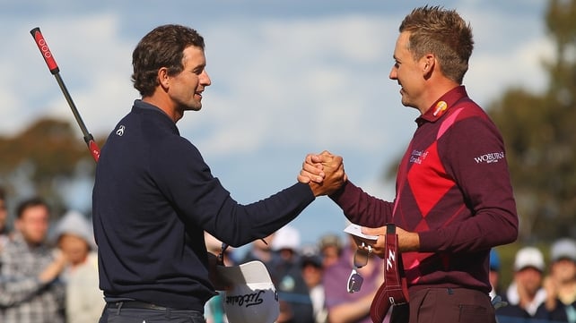 Ian Poulter congratulates tournament winner Adam Scott on the 18th hole