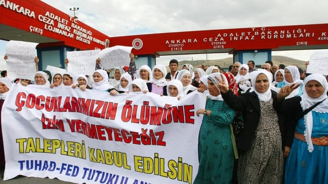 Kurdish women hold a banner reading 'We will not let our children die' as they demonstrate outside a prison in Sincan, near Ankara Kurdish women hold a banner reading 'We will not let our children die' as they demonstrate outside a prison in Sincan, near Ankara