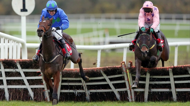 Hurricane Fly and Ruby Walsh jump the last in front of Go Native, which stumbles and falls shortly after the flight