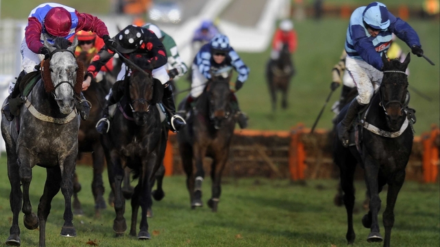 Paddy Brennan drives Olofi (left) to victory in the Racing Post Hurdle, with Cash And Go (right) third