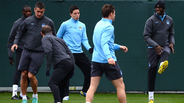 Mario Balotelli (R) trains earlier today despite being doubtful