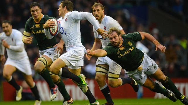 Alex Goode of England breaks away from South Africa's Jannie du Plessis