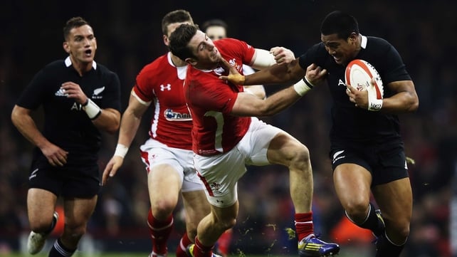 Julian Savea of the All Blacks fends off Wales' Alex Cuthbert