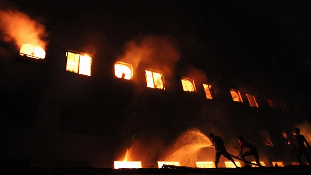 Bangladeshi people and firefighters trying to extinguish the fire Bangladeshi people and firefighters trying to extinguish the fire