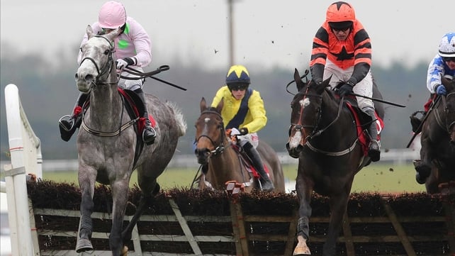 Barry Geraghty delivers Jezki (orange) with a perfectly-timed run to beat Champagne Fever (pink) in the Royal Bond Novice Hurdle