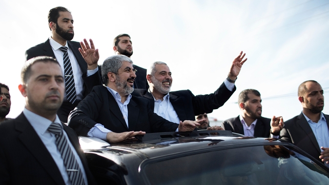 Hamas leader-in-exile Khaled Meshaal (C-L) and Hamas leader in Gaza Ismail Haniya (C-R) wave from the rooftop of a vehicle Hamas leader-in-exile Khaled Meshaal (C-L) and Hamas leader in Gaza Ismail Haniya (C-R) wave from the rooftop of a vehicle