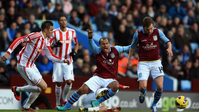 Gabriel Agbonlahor is fouled by Stoke's Geoff Cameron as Brett Holman comes away with the ball at Villa Park