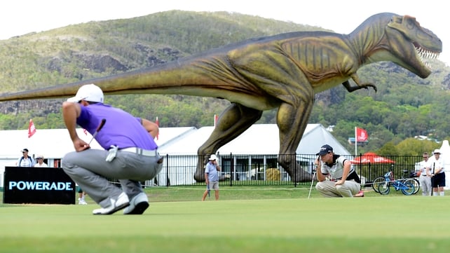 Matthew Stieger lines up a putt trying not to notice the giant model T-Rex dinosaur at the Palmer Coolum Resort