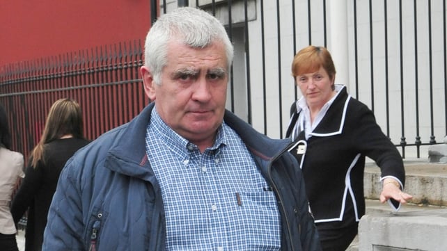 Donal Connaughton and his wife Margaret, seen in the background, are both facing multiple charges Donal Connaughton and his wife Margaret, seen in the background, are both facing multiple charges