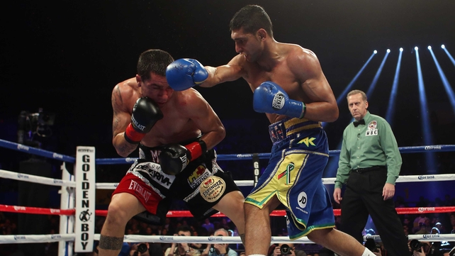 Amir Khan of Great Britain (right) throws a right hand at Carlos Molina during their vacant WBC silver super lightweight title fight at Los Angeles Sports Arena