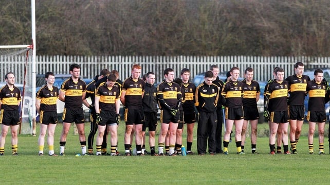 The Dr Crokes team observe a minutes' silence for Páidí Ó Sé at today's game