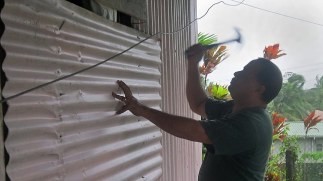 Local resident Aisea Latu nails a sheet of corrugated metal onto the shutters of his house on Laucala Bay Road, Suva Local resident Aisea Latu nails a sheet of corrugated metal onto the shutters of his house on Laucala Bay Road, Suva
