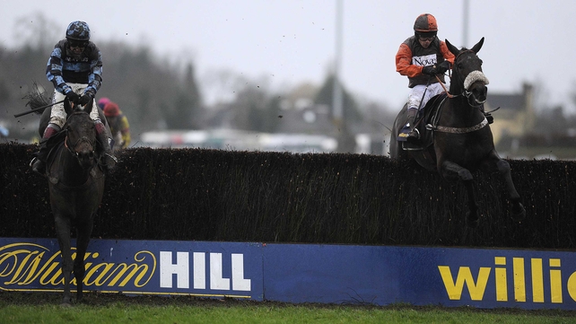 Sam Waley-Cohen riding Long Run (right) clear of the last to win the William Hill King George VI from Captain Chris (left) at Kempton
