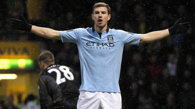 Edin Dzeko back among the goals for Manchester City as the champions held on for victory