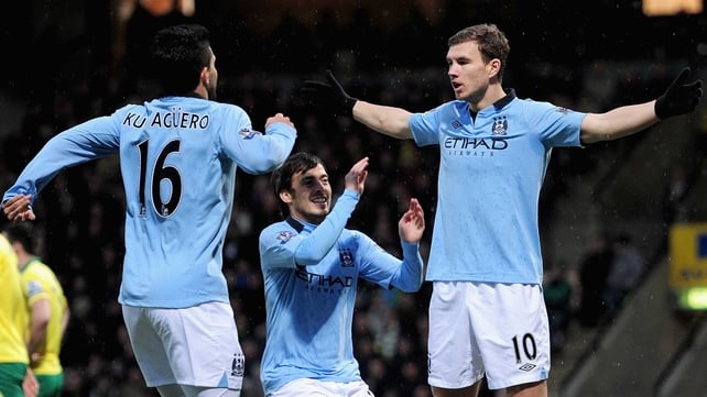 Sergio Aguero and David Silva rush to congratulate goal scorer Edin Dzeko