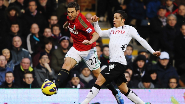 Swansea's Angel Rangel evades Fulham's Bryan Ruiz