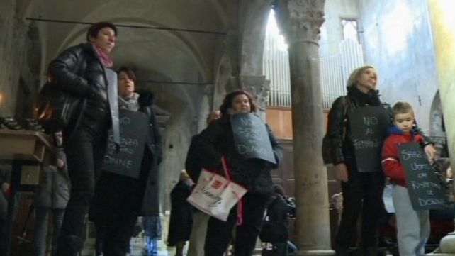 Women with placards in the church Women with placards in the church