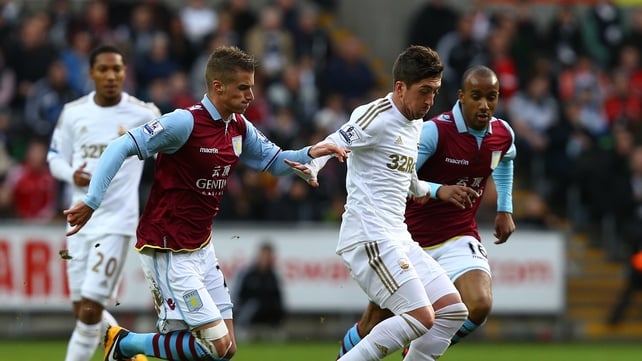 Pablo Hernandez of Swansea City battles with Andreas Weimann of Aston Villa
