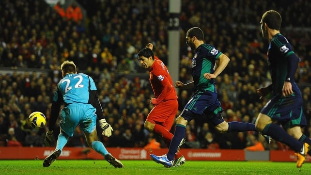 Luis Suarez scores Liverpool's third goal at Anfield