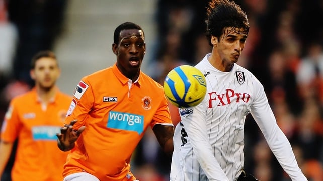 Isaiah Osbourne (l) of Blackpool challenges Bryan Ruiz of Fulham