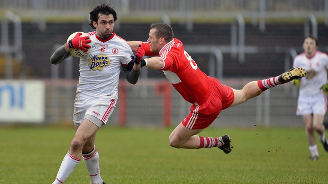 Tyrone's Joe McMahon and Paddy Bradley of Derry battle for possession in Healy Park