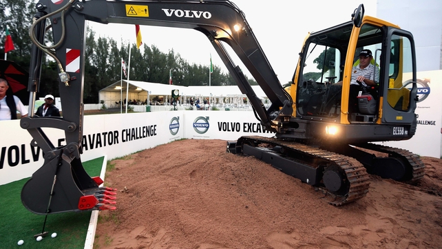 The R&A won't like it - An engrossed Louis Oosthuizen practices an unorthodox putting technique from the bunker utilising the bucket of his excavator