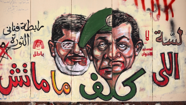 Graffiti depicting Egyptian President Mohamed Morsi (L), ousted president Hosni Mubarak (R) and former head of the army Field Marshal Mohammed Hussein Tantawi Graffiti depicting Egyptian President Mohamed Morsi (L), ousted president Hosni Mubarak (R) and former head of the army Field Marshal Mohammed Hussein Tantawi